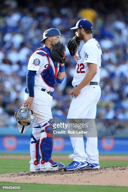 Yasmani Grandal and Clayton Kershaw of the Los Angeles Dodgers meet on the mound during the game against the San Francisco Giants at Dodger Stadium...