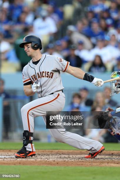 Buster Posey of the San Francisco Giants bats during the game against the Los Angeles Dodgers at Dodger Stadium on Thursday, March 29, 2018 in Los...