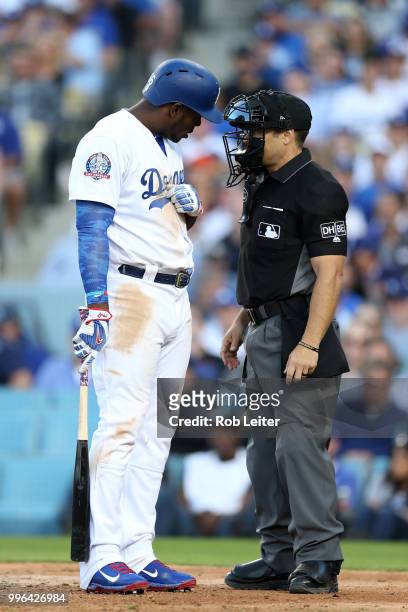 Yasiel Puig of the Los Angeles Dodgers and umpire Mark Wagner argue during the game against the San Francisco Giants at Dodger Stadium on Thursday,...