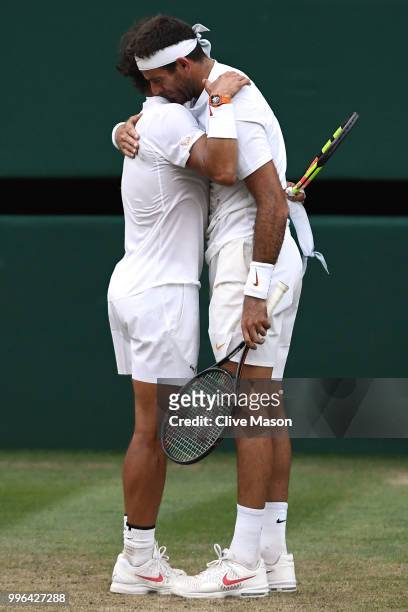 Rafael Nadal of Spain and Juan Martin Del Potro of Argentina embrace following their Men's Singles Quarter-Finals match on day nine of the Wimbledon...