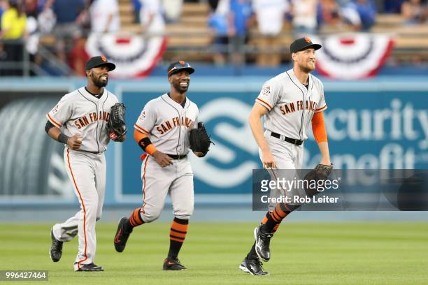 Hunter Pence, Austin Jackson and Andrew McCutchen of the San Francisco Giants run off the field after winning the game against the San Francisco...