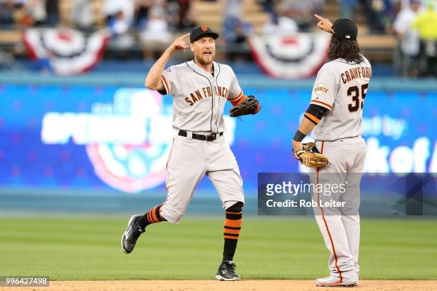 Hunter Pence and Brandon Crawford of the San Francisco Giants celebrate after winning the game against the Los Angeles Dodgers at Dodger Stadium on...