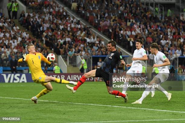 Jordan Pickford of England makes a save from Mario Mandzukic of Croatia during the 2018 FIFA World Cup Russia Semi Final match between England and...