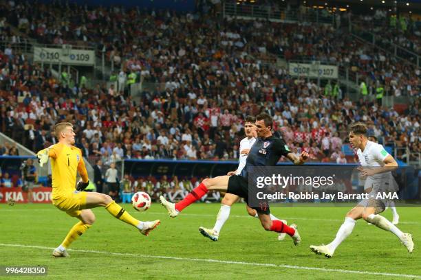 Jordan Pickford of England stops the attempt on goal of Mario Mandzukic of Croatia in extra time during the 2018 FIFA World Cup Russia Semi Final...