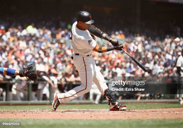 Gorkys Hernandez of the San Francisco Giants hits a double that scored two runs in the first inning against the Chicago Cubs at AT&T Park on July 11,...