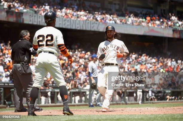 Andrew McCutchen and Brandon Crawford of the San Francisco Giants both score on a hit by Gorkys Hernandez of the San Francisco Giants in the first...