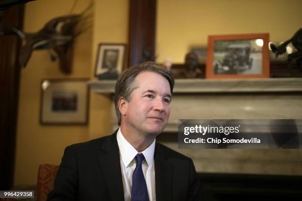 Judge Brett Kavanaugh listens to Sen. Rob Portman talk about Kavanaugh's qualifications before a meeting in the Russell Senate Office Building on...