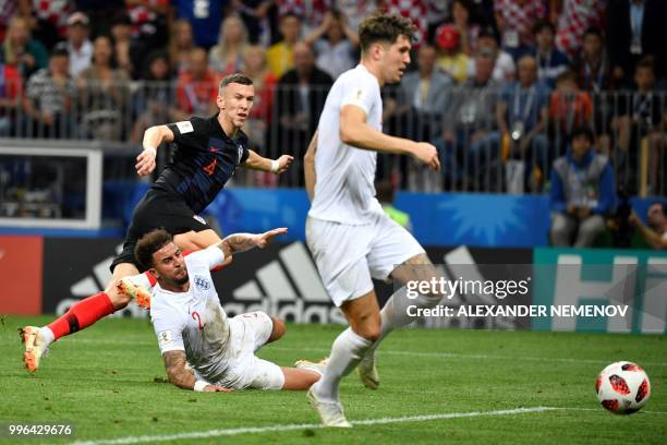 Croatia's forward Ivan Perisic attempts a shot in front of England's defender Kyle Walker during the Russia 2018 World Cup semi-final football match...