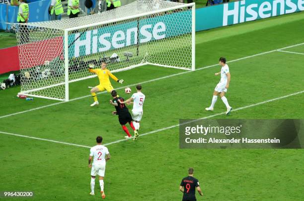 Mario Mandzukic of Croatia scores past Jordan Pickford of England his team's second goal during the 2018 FIFA World Cup Russia Semi Final match...