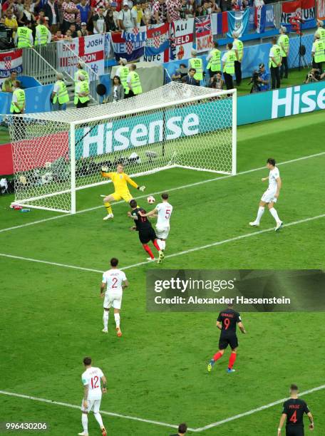 Mario Mandzukic of Croatia scores past Jordan Pickford of England his team's second goal during the 2018 FIFA World Cup Russia Semi Final match...