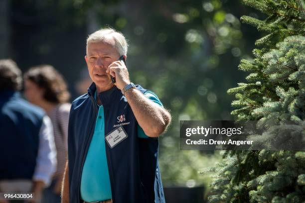 Lowell McAdam, chairman and chief executive officer of Verizon Communications, talks on his cell phone during the annual Allen & Company Sun Valley...