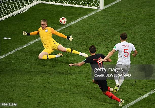 Croatia's forward Mario Mandzukic shoots and scores his team's second goal during the Russia 2018 World Cup semi-final football match between Croatia...