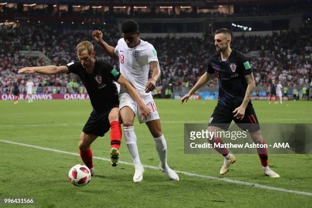 Nikola Kalinic of Croatia and Marcus Rashford of England during the 2018 FIFA World Cup Russia Semi Final match between England and Croatia at...