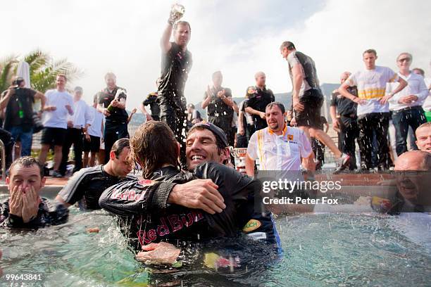 Mark Webber of Australia and Red Bull Racing celebrates by diving into the Red Bull Energy Station swimming pool after winning the Monaco Formula One...