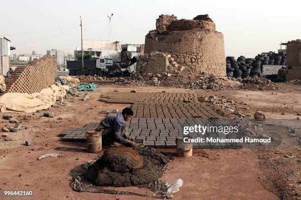 Worker makes bricks at a mud bricks factory on July 07, 2018 in north Sana’a, Yemen. A mudbrick or mud-brick is a brick which dates back thousands of...