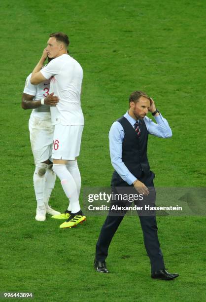 Danny Rose, Phil Jones and Gareth Southgate of England show their dejection following the 2018 FIFA World Cup Russia Semi Final match between England...