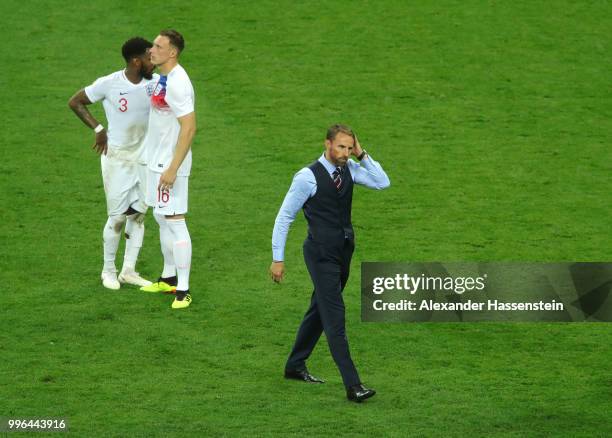 Danny Rose, Phil Jones and Gareth Southgate of England show their dejection following the 2018 FIFA World Cup Russia Semi Final match between England...