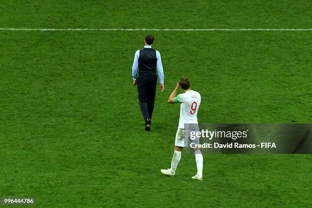 Gareth Southgate and Harry Kane of England walk off the pitch dejected following their team's defeat in the 2018 FIFA World Cup Russia Semi Final...