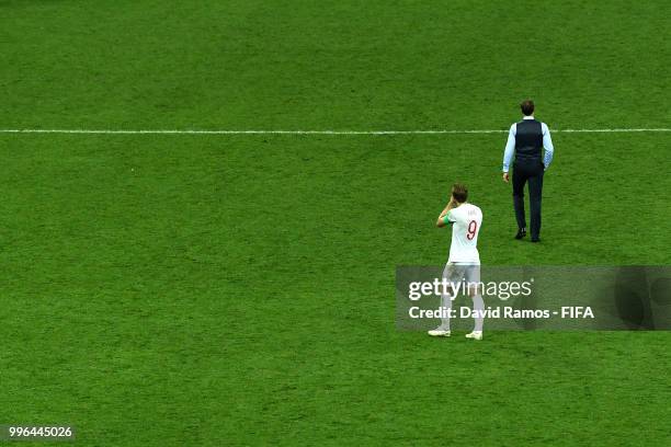 Gareth Southgate and Harry Kane of England walk off the pitch dejected following their team's defeat in the 2018 FIFA World Cup Russia Semi Final...