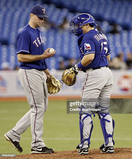 Matt Treanor talks to Scott Feldman of the Texas Rangers during a MLB game against the Toronto Blue Jays at the Rogers Centre May 15, 2010 in...