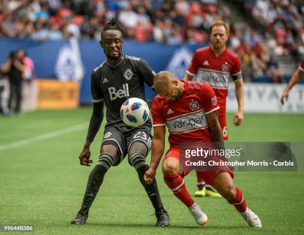 Kei Kamara of the Vancouver Whitecaps FC and Kevin Ellis of the Chicago Fire at BC Place on July 7, 2018 in Vancouver, Canada.