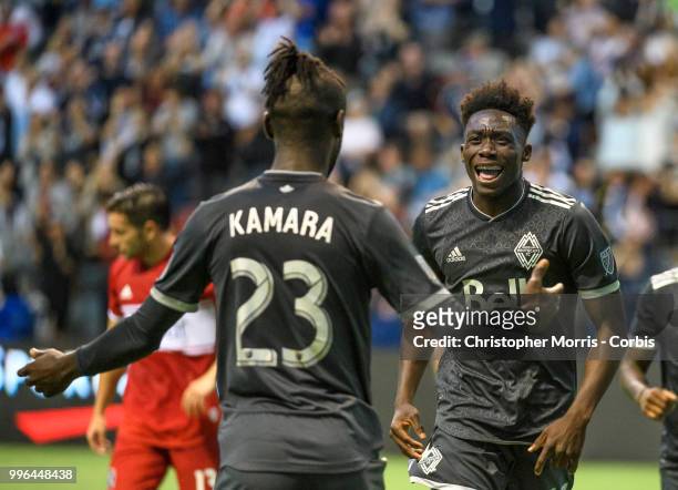 Kei Kamara of the Vancouver Whitecaps FC is congratulated by Alphonso Davies of the Vancouver Whitecaps FC after his goal against the the Chicago...