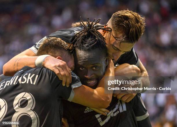 Kei Kamara of the Vancouver Whitecaps FC is congratulated on his goal by teammates Jake Nerwinski and Jose Aja against the Chicago Fire at BC Place...