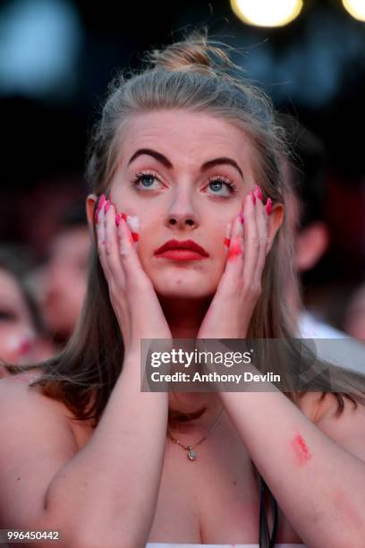 Football fans react as they watch England lose to Croatia at the Auto Trader World Cup semi-final screening in Castlefield Bowl on July 11, 2018 in...