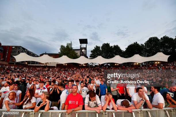 Football fans react as they watch England lose to Croatia at the Auto Trader World Cup semi-final screening in Castlefield Bowl on July 11, 2018 in...