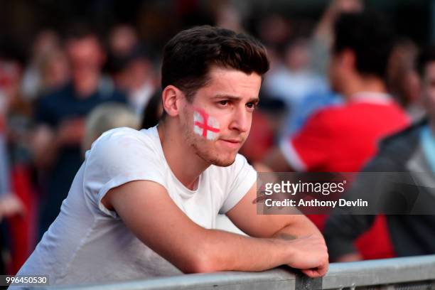 Football fans react as they watch England lose to Croatia at the Auto Trader World Cup semi-final screening in Castlefield Bowl on July 11, 2018 in...