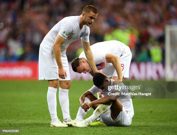 Eric Dier and Phil Jones of England console teammate Marcus Rashford of England after England's defeat in the 2018 FIFA World Cup Russia Semi Final...