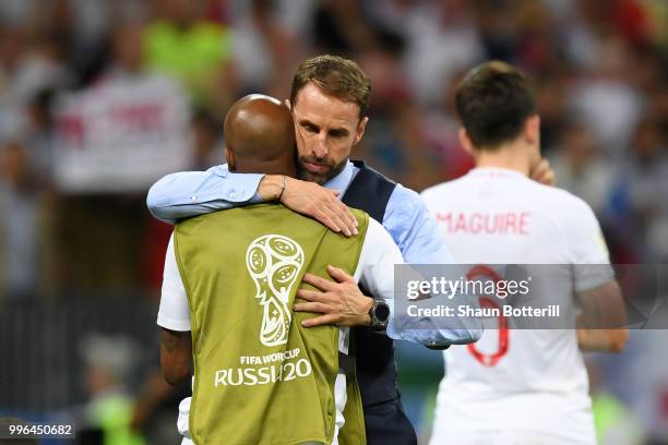 Gareth Southgate, Manager of England consoles Fabian Delph of England following their sides defeat in the 2018 FIFA World Cup Russia Semi Final match...