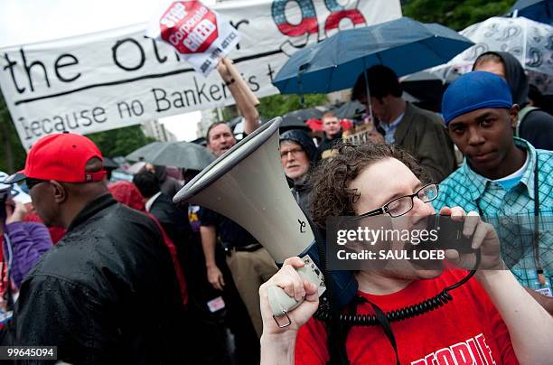 Sam Finkelstein of Chicago with the National People's Action group shouts slogans as the group marches through the streets of Washington on May 17,...