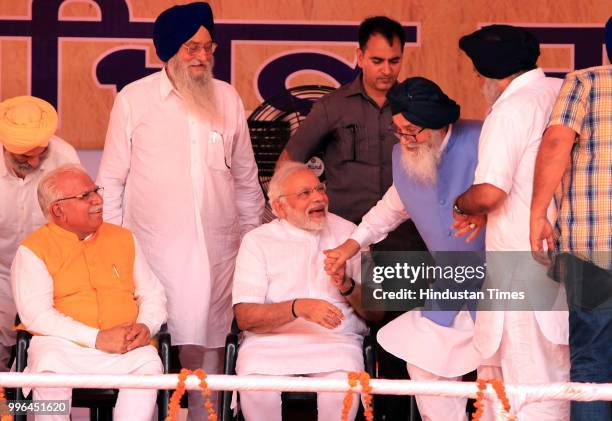 Former Chief Minister Parkash Singh Badal leaving his chair holding the hand of Prime Minister Narendra Modi and his son and former Punjab deputy...