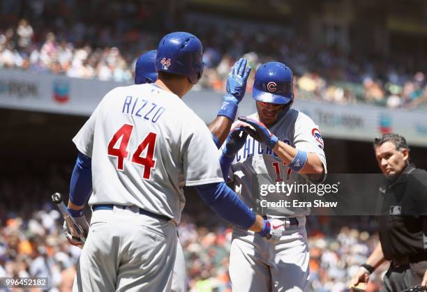 Kris Bryant of the Chicago Cubs is congratulated by Jason Heyward and Anthony Rizzo after hitting a two-run home run in the fifth inning against the...