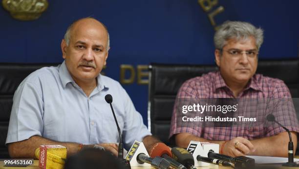 Deputy Chief Minister Manish Sisodia addresses a press conference as Delhi Transport Minister Kailash Gahlot looks on at Delhi secretariat on July...