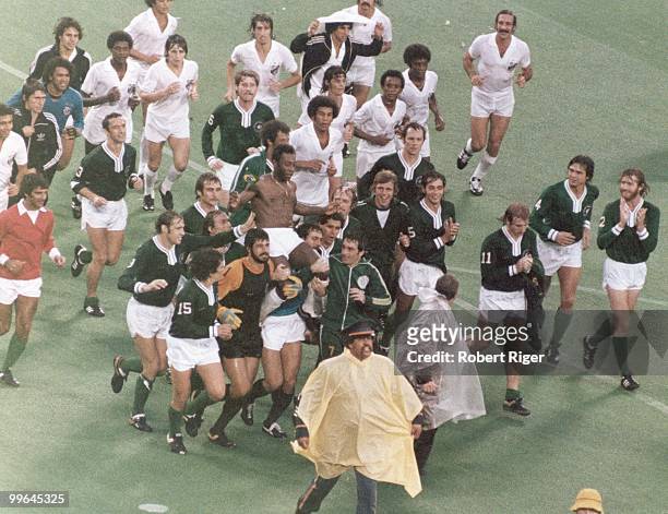 Pele leaves the field following his final game. Pele played for his two club teams, New York Cosmos in the first half and Santos FC in the second...
