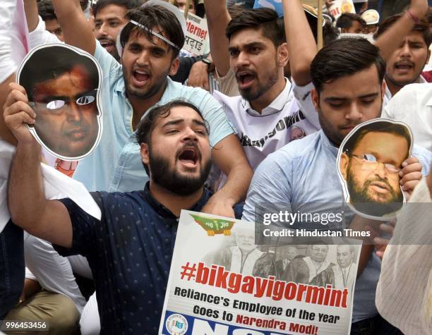 National Students' Union of India activists and supporters raise slogans during a protest against Narendra Modi for granting institute of eminence...