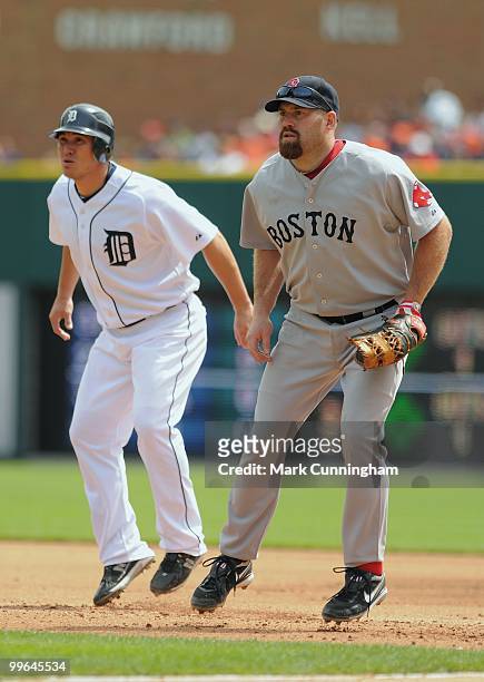 Magglio Ordonez of the Detroit Tigers gets a lead off first base while Kevin Youkilis of the Boston Red Sox gets ready to field during the game at...