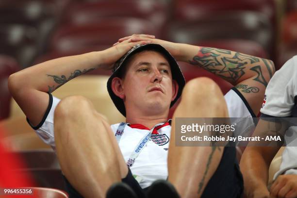 An England fan looks dejected at the end of extra time during the 2018 FIFA World Cup Russia Semi Final match between Croatia and England at Luzhniki...