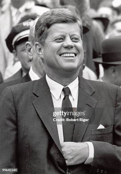 President John F. Kennedy watches the Opening Day game between the Washington Senators and Detroit Tigers at D.C. Stadium on April 9, 1962 in...