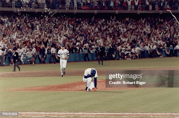 Orel Hershiser of the Los Angeles Dodgers kneels on the mound following the final out of Game Seven of the 1988 National League Championship Series...