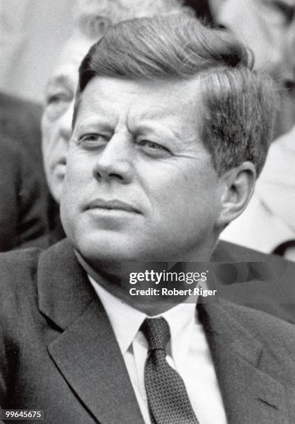 President John F. Kennedy watches the Opening Day game between the Washington Senators and Detroit Tigers at D.C. Stadium on April 9, 1962 in...