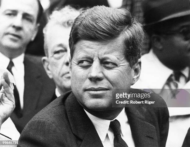 President John F. Kennedy watches the Opening Day game between the Washington Senators and Detroit Tigers at D.C. Stadium on April 9, 1962 in...