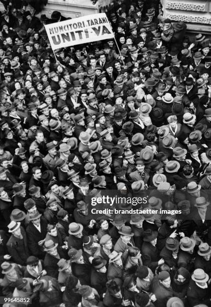 Big crowd met in front of the election tribune of the national countrymen-party in Bucharest. The poster says: 'worker and countrymen come together!'...