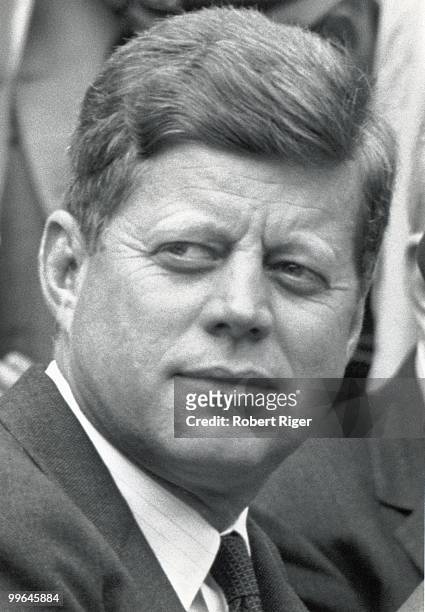 President John F. Kennedy watches the Opening Day game between the Washington Senators and Detroit Tigers at D.C. Stadium on April 9, 1962 in...