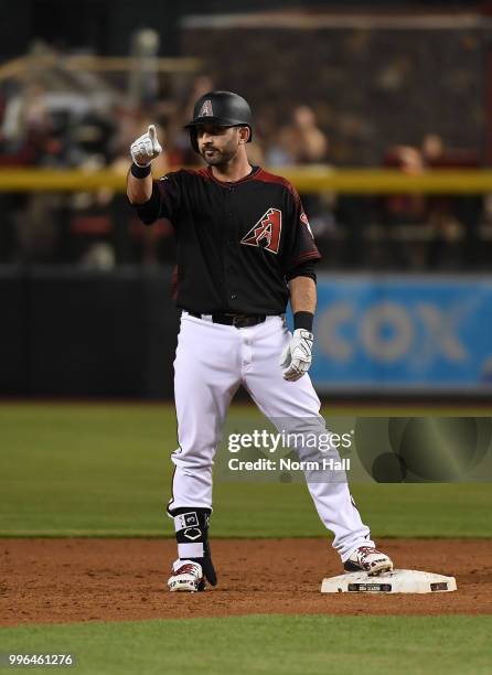 Daniel Descalso of the Arizona Diamondbacks gestures to his dugout after hitting a double against the San Diego Padres at Chase Field on July 7, 2018...