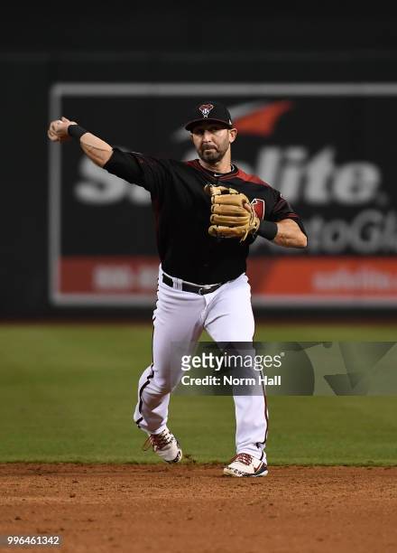 Daniel Descalso of the Arizona Diamondbacks makes a throw to first base against the San Diego Padres at Chase Field on July 7, 2018 in Phoenix,...