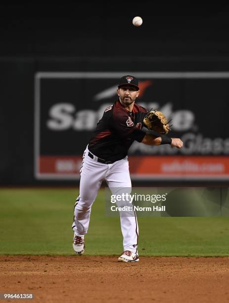 Daniel Descalso of the Arizona Diamondbacks makes a throw to first base against the San Diego Padres at Chase Field on July 7, 2018 in Phoenix,...