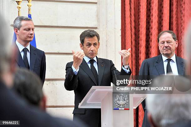 French President Nicolas Sarkozy delivers a speech beside French Agriculture Minister Bruno Le Maire and French Trade and Tourism Minister Herve...
